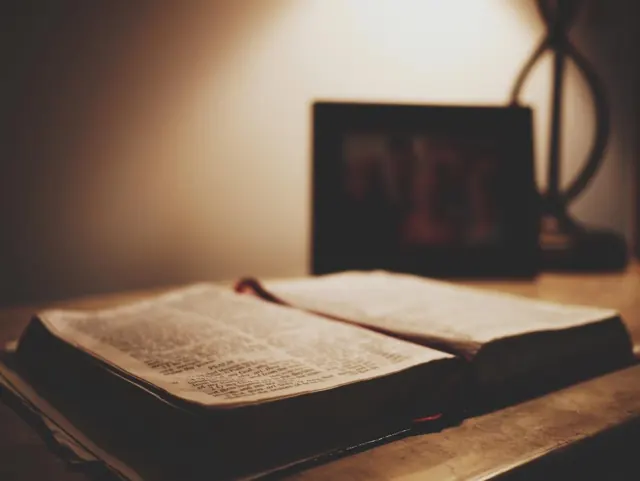 Open Bible under a warm reading lamp