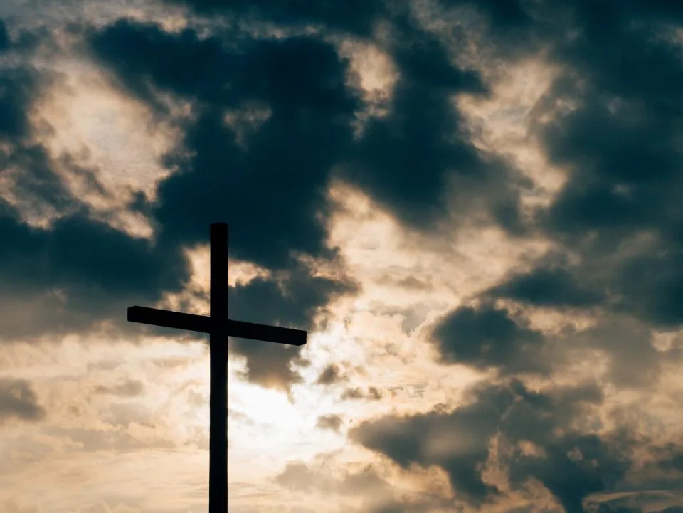 Cross against a dramatic cloudy sky